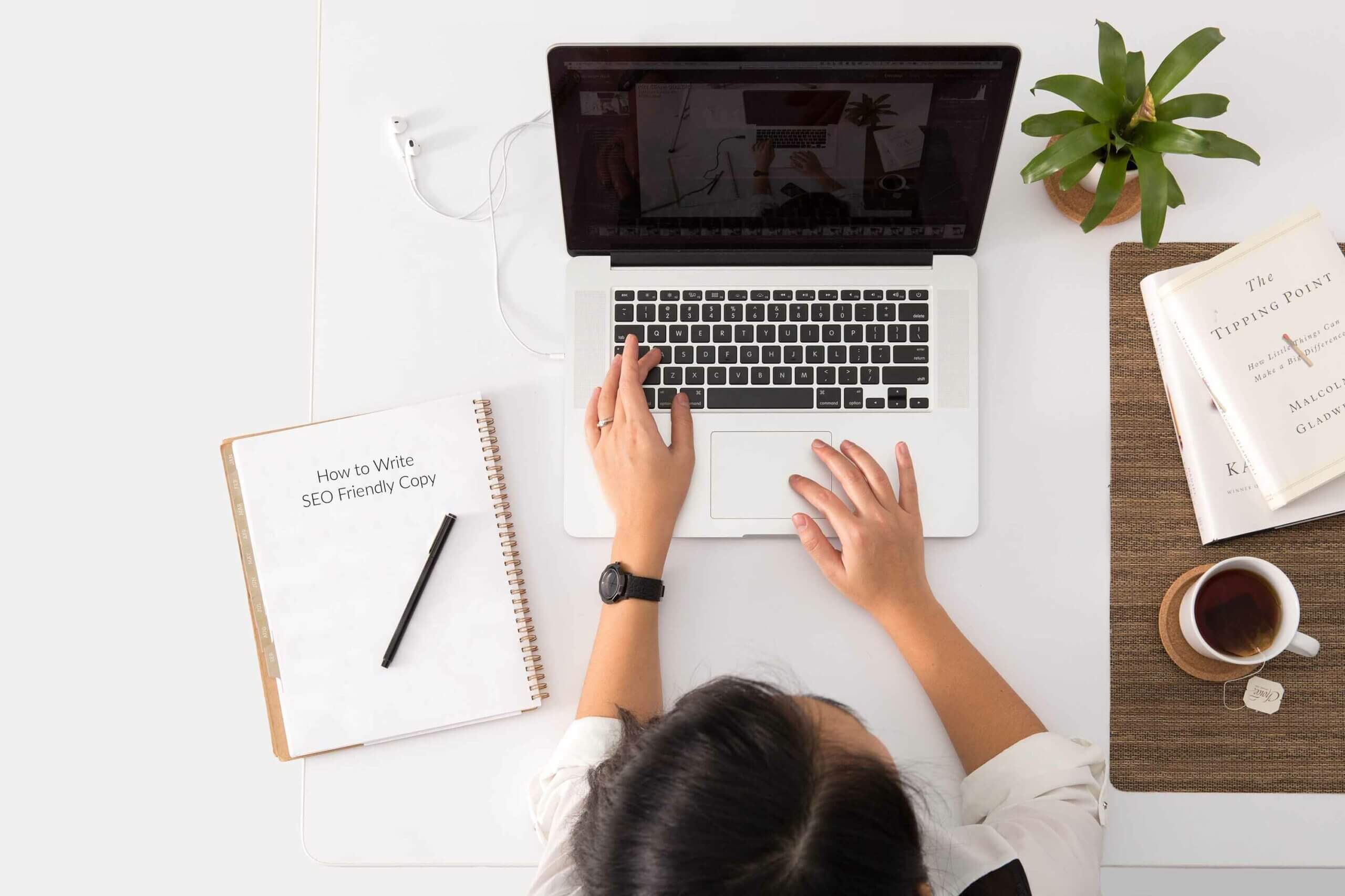 Woman at a desk ready to write SEO Friendly Copy