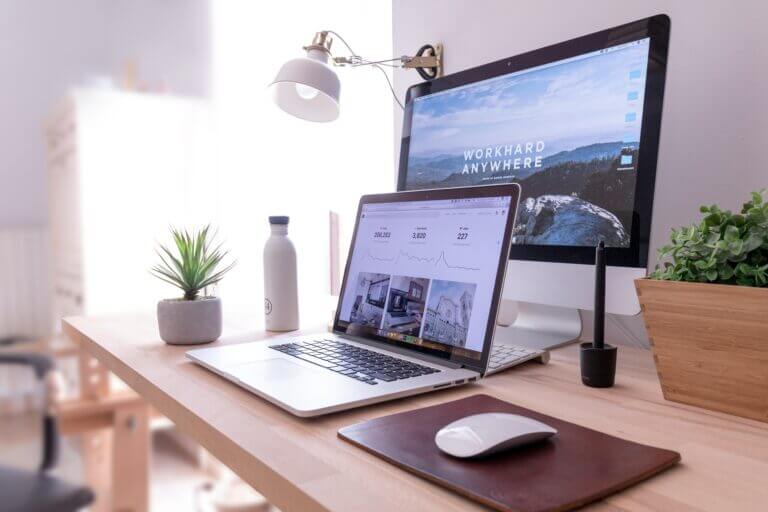 Website Design Tips — A desk with a laptop and monitor, ready for work