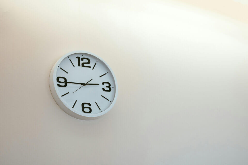 clock on a blank wall. Do you have the time, expertise and priority to build your website yourself, or should you leave it to a professional?